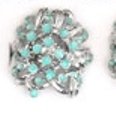 Improving Lifestyles Ribbon Style Ring with Specs of Color Blue