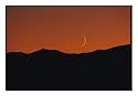 A Crescent Moon Sets over Mountains Rimming the Western Edge of Lake Tahoe Art Photographic Poster Print by George F. Mobley, 16x12