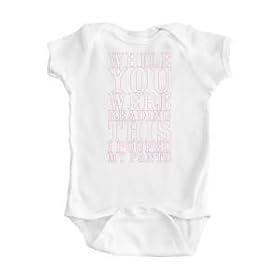 Girl's White Onesie with Humorous While You Were Reading Design