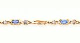 1.50ct total weight oval blue topaz & .05ct total weight diamond 7 bracelet set in 14kt gold.