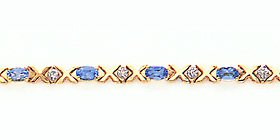 3.30ct total weight oval blue topaz CHANGITNOW .12ct total weight diamond 7 bracelet set in 14kt gold.