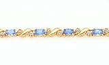 3.90ct total weight oval blue topaz & .25ct total weight diamond 7 bracelet set in 14kt gold.