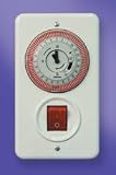 Shabbat clock for sun-heated water tank in the wall