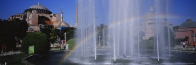 Water Fountain with a Rainbow in Front of Museum, Hagia Sophia, Istanbul, Turkey Premium Photographic Poster Print by Panoramic Images , 40x120
