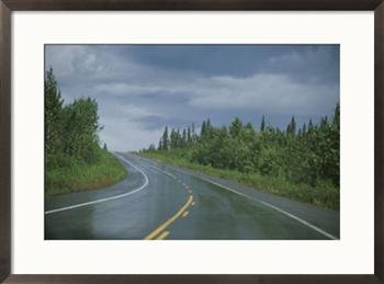 The Alaskan highway glistens from rainfall near Anchorage, Alaska Photography Framed Art Poster Print by Stacy Gold, 29x21