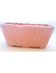 From Amazon.com. Click for details:
 Single Detail Page Misc: Vintage USA Pottery Pink Planter Vase Marked 113 Single Detail Page Misc: Vintage USA Pottery Pink Planter Vase Marked 113