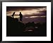A Man with a Camera Helps a Woman Down Rocks Near Tanah Lot Temple Framed Art Poster Print by Eightfish, 31x25