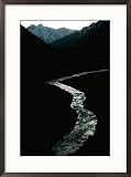 Glistening in the light, the Obhingo River flows down through the mountain vall eys of Tajikistan Subject Framed Art Poster Print by Barry Tessman, 21x29