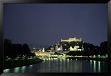 The City is Illuminated at Night Casting a Soft Glow onto the River, Salzburg, Austria Framed Art Poster Print by Taylor S. Kennedy, 55x38