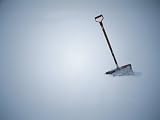 Deep Snow and a Lone, Well-Used Shovel Photographic Poster Print by Stephen St. John, 12x16