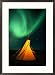 A solitary tepee is illuminated by the aurora borealis Framed Art Poster Print by Raymond Gehman, 21x29
