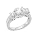 Sterling Silver Engagement Ring With Round Cubic Zirconia in a Four Prong Setting and Two Side Stones