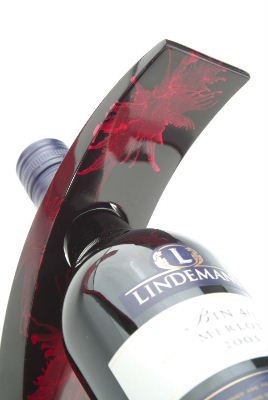 Balancing wine bottle holder stand made from lacquered wood in Red Splash design
