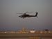 AH-64 Apache Helicopter Flies by the Control Tower on Camp Speicher Photographic Poster Print by Stocktrek Images , 18x24