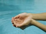 A Model Lets Water Pass Through Her Cupped Hands at a Swimming Pool Photographic Poster Print, 24x18