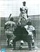 Yogi Berra autographed 8x10 Photo (New York Yankees) pictured catching with Jackie Robinson at bat