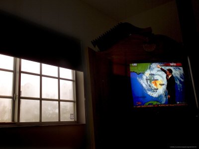 Stormy View outside Window with Television Displaying a Hurricane Watch National Geographic Collection Photographic Poster Print by Raul Touzon, 56x42