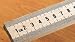 Meter stick; Maple wood; Scaled in millimeters on one side and inches on the other