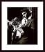 All Products : Elvis Reading the Sunday Mirror * by Anon 18.00X24.00 Framed with Black Wood Frame