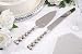 Wedding cake knife and server set with heart shaped handles. ::Knife is 13 inches in length. Server 11 inches long.::Both knife and server are metal with silver finish