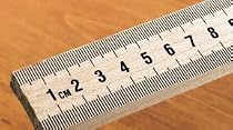 Meter stick; Maple wood; Scaled in millimeters on one side and inches on the other; With metal ends
