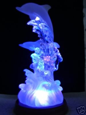 Artistic Dolphins Figurine on Waves of Light