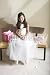 Wallmonkeys Peel and Stick Wall Decals - Girl (8-10), Dressed in Bridesmaid Dress, Sitting beside Wedding Gift on Bench, Smiling, Front View, Portrait - Removable Graphic