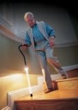 Walking cane with safety light has ergonomic grip handle for comfort with push button to illuminate the lower half of the cane. Adjustable in 1 increments.