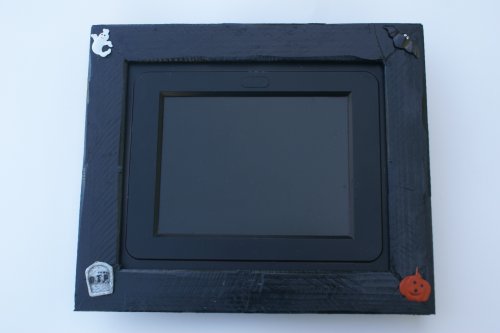 Voclan 8LCD by SHARP.Includes Black rustic wood frame with Halloween accents.Change the frame when Haloween is over.Its the ONLY ONE that fits most 8x10 picture frames. Play MP3  Video in stereo