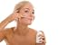 Woman Applying Cream on Cheek - 18W x 12H - Peel and Stick Wall Decal by Wallmonkeys