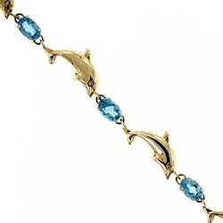 Oval Blue Topaz Dolphin Link Bracelet 7 Inch in Solid Yellow Gold