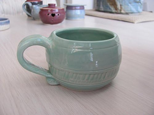 Handmade Ceramic Tea Cup Pottery Coffee Mug in Aqua Mint Turquoise with Cream Colored Chattered Texture Pattern.