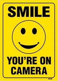 SMILE YOU’RE ON CAMERA 14×10 Heavy Duty Plastic Sign