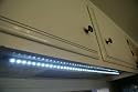 New.LED under cabinet 30 inch strip light, 45 super bright LEDs. Has 12volt ac adapter. Save money with low energy usuage, long life (50,000 hour) LEDs.Great for Kitchen, RV,garage, computer cubicle,etc. Ultra slim styling. Bring the light to where the work area is.No toxic mercury like florescents.I run mine off a small solar panel for a 12v battery.