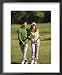 Mid Adult Man and a Mid Adult Woman on a Golf Course Framed Art Poster Print, 18x22