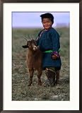Boy Wearing Traditional Dell Standing Next to Baby Goat, Mongolia Framed Art Poster Print by Jerry Galea, 21x29