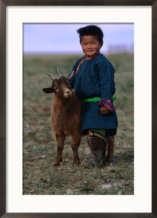 Boy Wearing Traditional Dell Standing Next to Baby Goat, Mongolia Framed Art Poster Print by Jerry Galea, 21x29