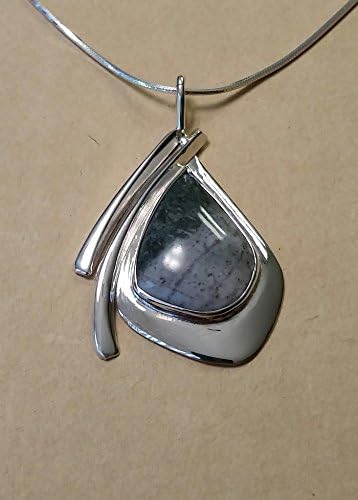 Calaverite (rare) in a light to medium gray natural stone matrix, set in a modern, abstract Sterling Silver pendant with Sterling Silver Chain.