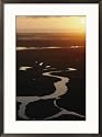 The sun sets over waterways on Cumberland Island Photography Framed Art Poster Print by Jodi Cobb, 21x29
