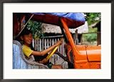 Boy Pretending to Drive Truck in Mrauk-U Village, Looking at Camera, Mrauk U, Myanmar (Burma) Framed Photographic Poster Print by Corey Wise, 29x21