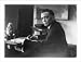 Historic Print (L): [J. Edgar Hoover, half-length portrait, facing left, seated at desk, holding pen]