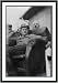 Historic Print (L): [Goering lounges in chair, two friends behind]