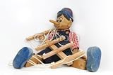 Wallmonkeys Peel and Stick Wall Decals - Pinocchio Sitting on White Background - Removable Graphic