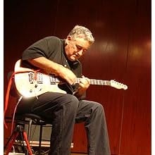 Fred Frith - http://upload.wikimedia.org/wikipedia/commons/thumb/1/1a/FredFrith_August2006.jpg/210px-FredFrith_August2006.jpg