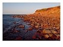 The Almost Unnatural Red of the Rocks of the Island Light up at Sunset, Prince Edward Island, Canada Photographic Poster Print by Taylor S. Kennedy, 24x18
