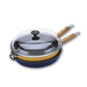 World Cuisine 11 inch diameter cast-iron frying pan with wooden handle and glass lid. The pan's interior is black with an exterior of green.