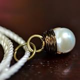 Sea Stone Pendant - white pearl wire wrapped in bronze with ivory cord