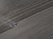 Aerial View of a Tractor Pulling a Plow across a Field Photographic Poster Print by Michael Polzia, 40x30