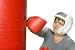 Woman in Her 60s Hitting a Punching Bag. - 24W x 16H - Peel and Stick Wall Decal by Wallmonkeys