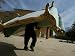 An Iraqi Man Trudges Under the Weight of a Couch He Looted from a Gated Elite Housing Compound Photographic Poster Print, 12x16